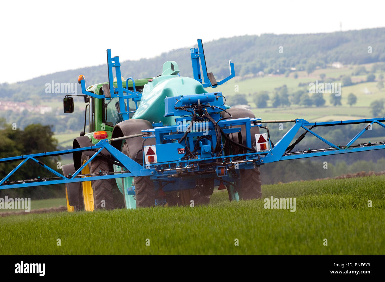 Farmer spraying spring barley crop with herbicide Stock Photo Alamy