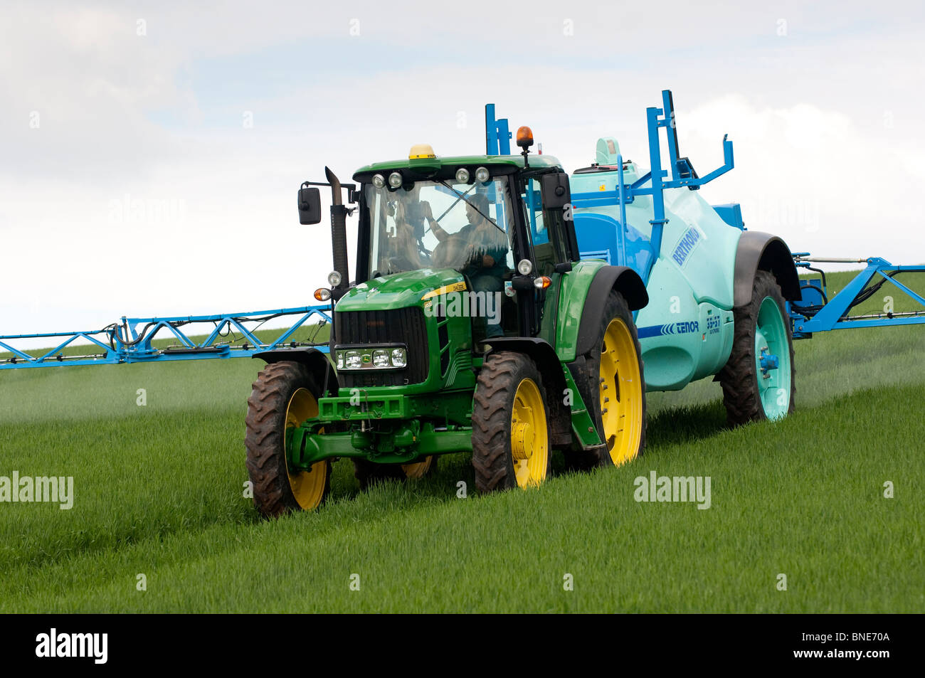 Farmer spraying spring barley crop with herbicide Stock Photo Alamy