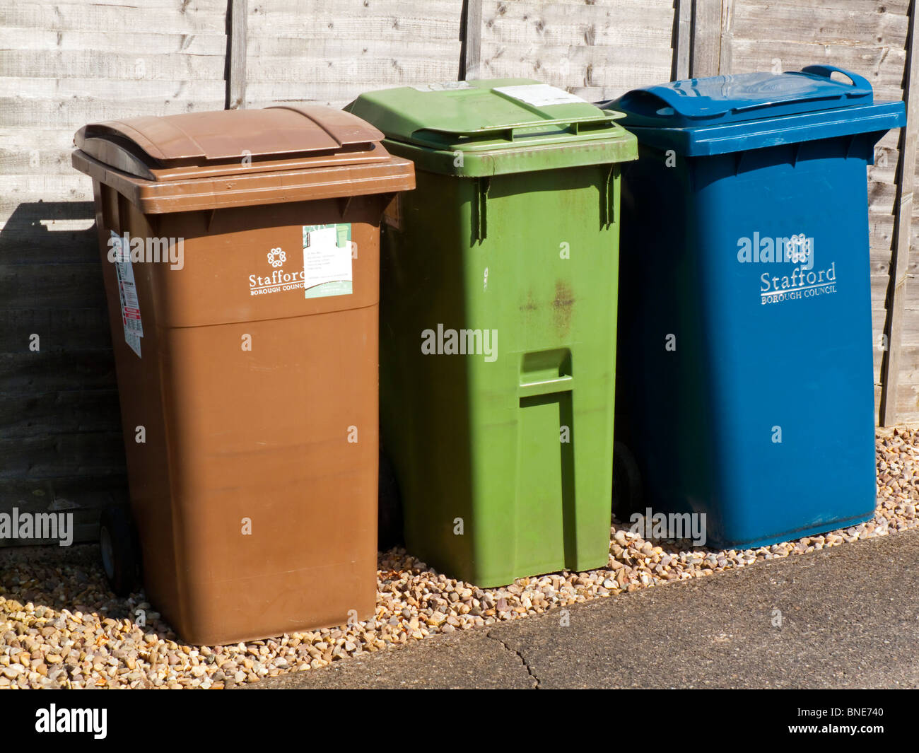 Coloured wheelie bins provided by Stafford Borough Council for recycling  different types of household waste in Staffordshire UK Stock Photo - Alamy