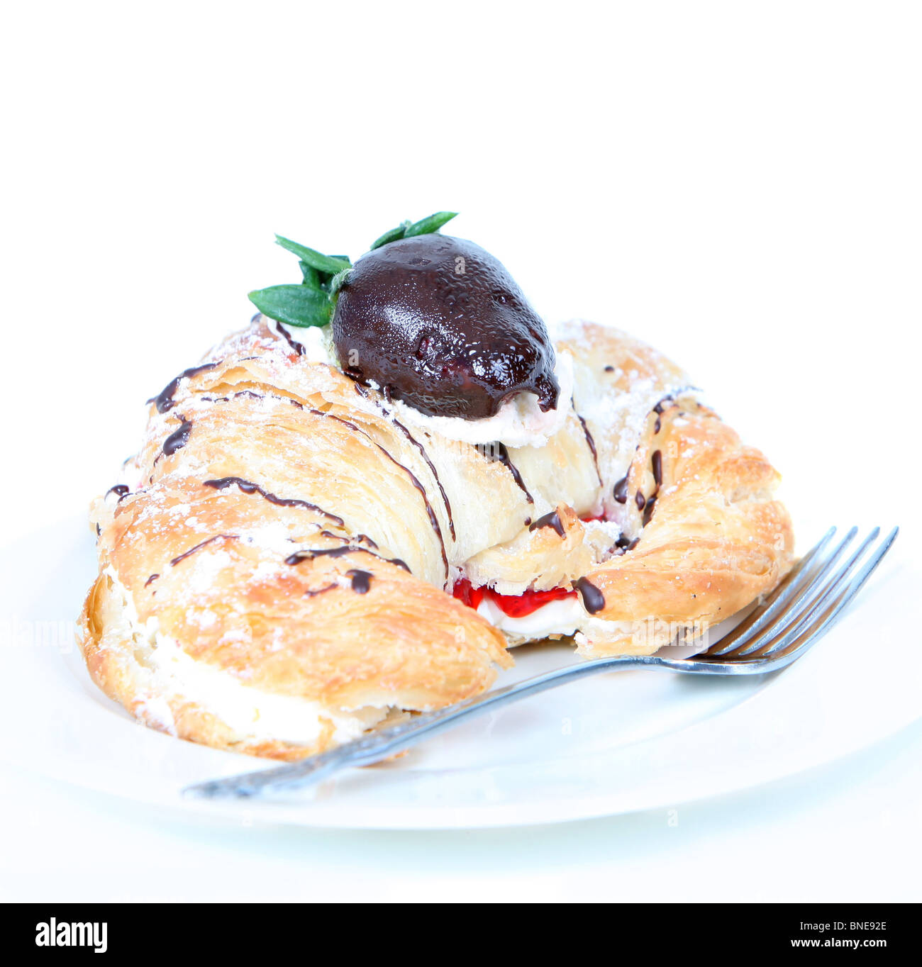Cream filled croissant with chocolate strawberry Stock Photo