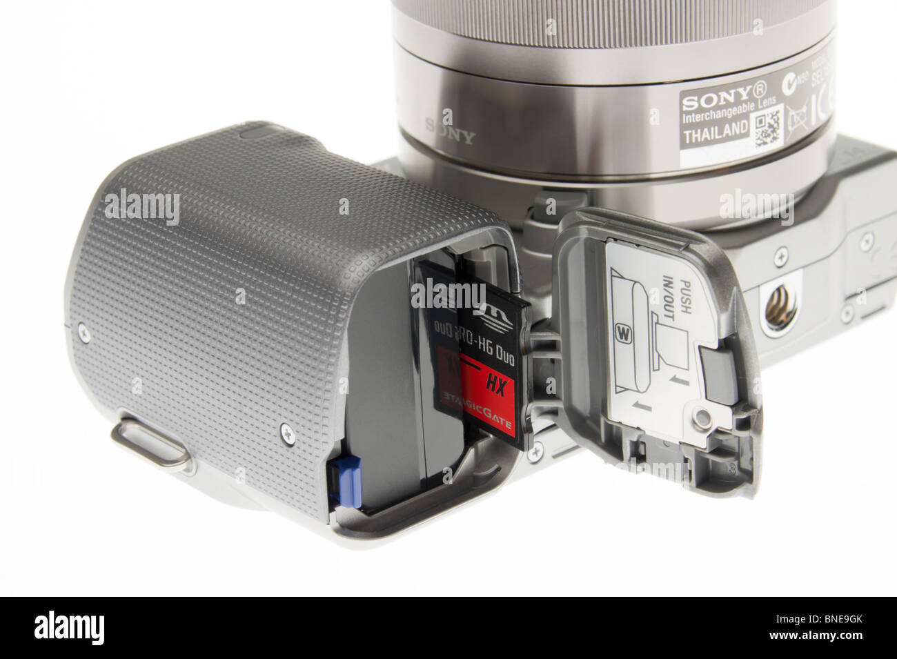 Sony Alpha NEX system - NEX-5 battery compartment door with battery and memory card storage Stock Photo