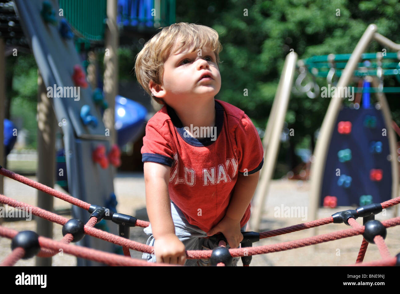 young boy playing in playground Stock Photo - Alamy
