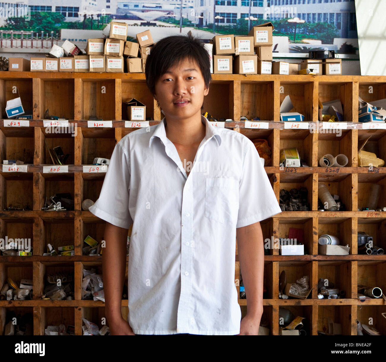 Portrait of a young man standing in a store, China Stock Photo - Alamy