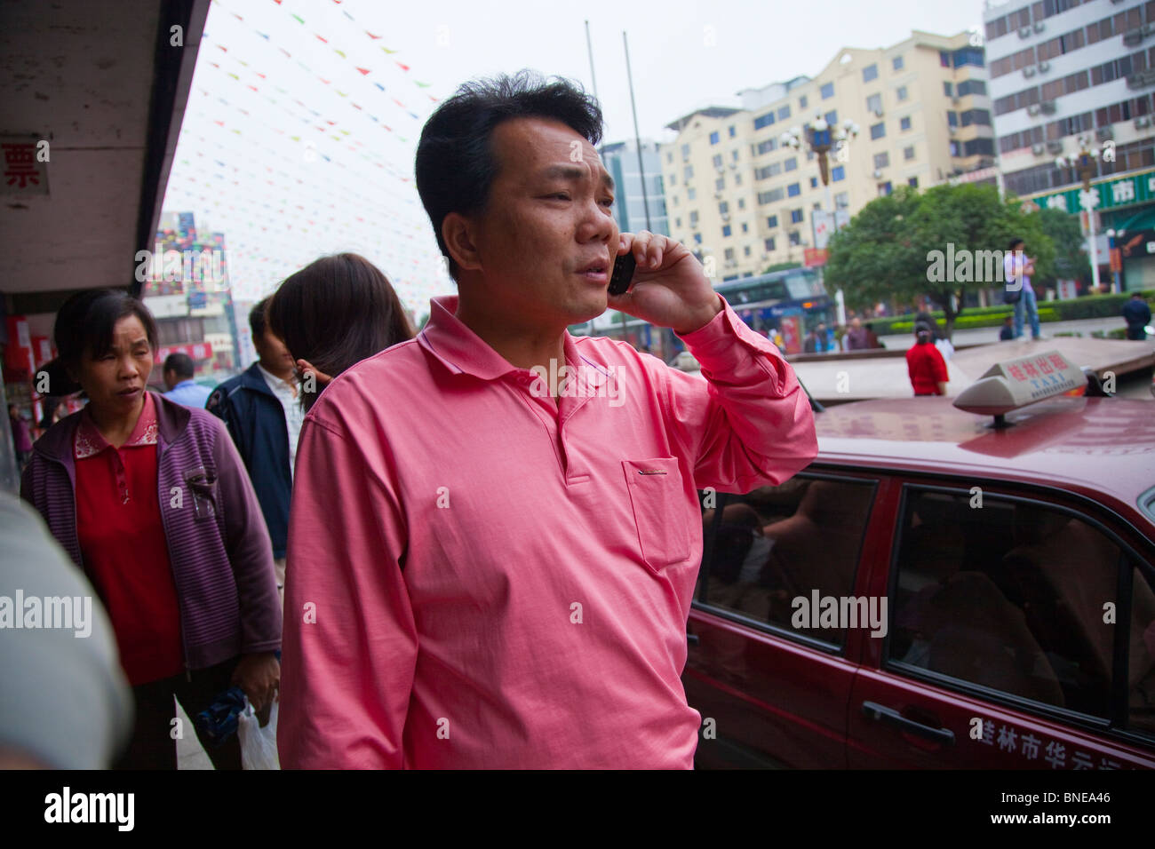 Chinese man talking on a mobile phone in Guilin, Guangxi Province, China Stock Photo