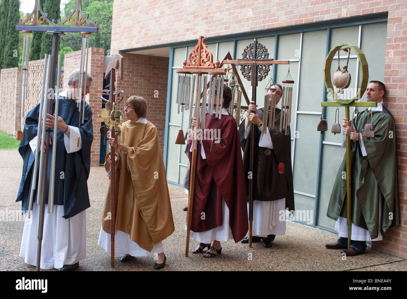 Choir members hold ceremonial wind chimes before entering the sanctuary
