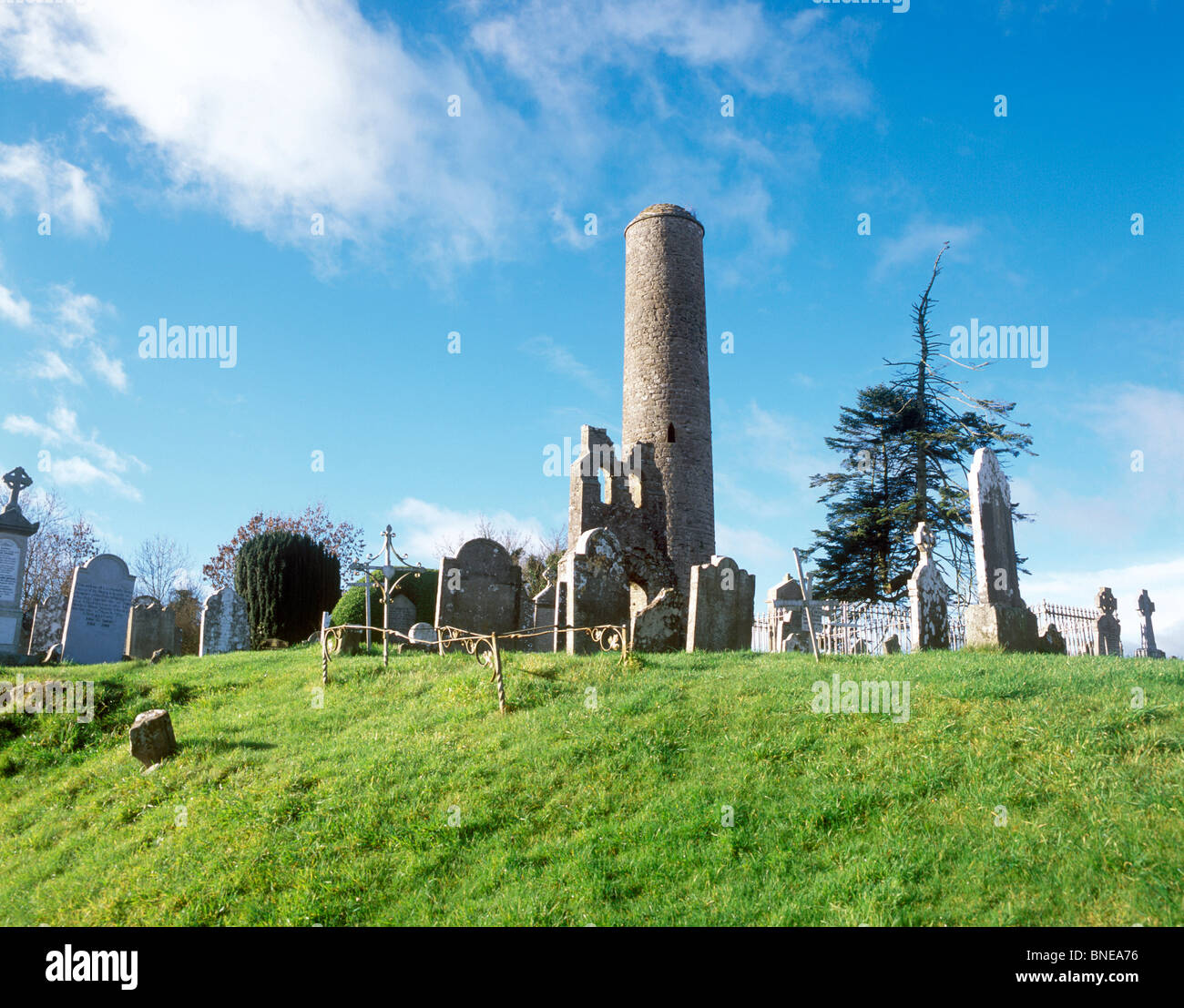 Low angle view of a tower in a cemetery, Donaghmore Round Tower, Navan, County Meath, Leinster Province, Republic of Ireland Stock Photo