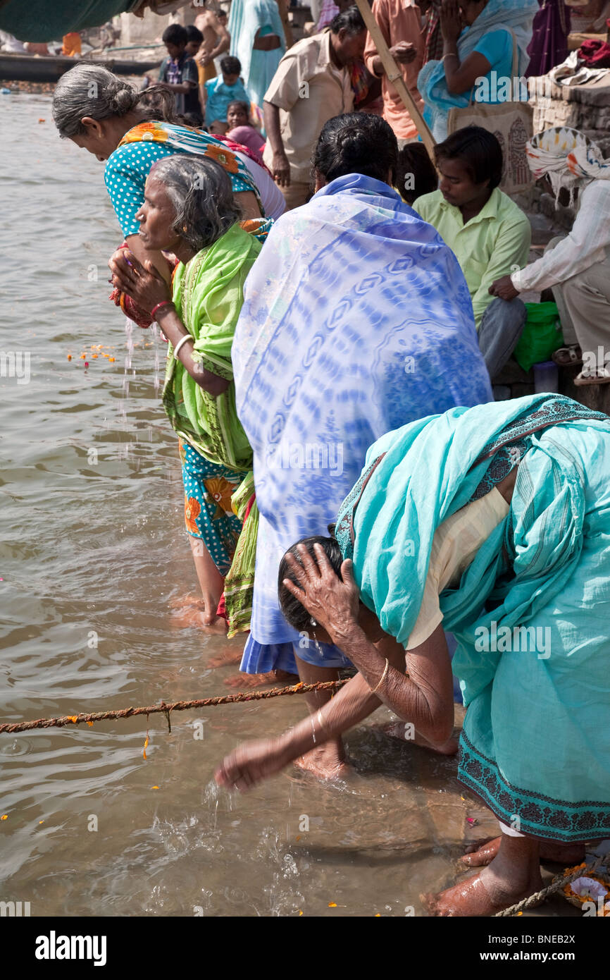 Indian women praying in the Ganges river. Varanasi (Benares). India Stock Photo