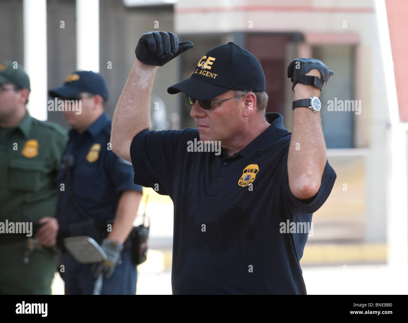 U.S. federal Border Patrol agent directs traffic as vehicles headed to