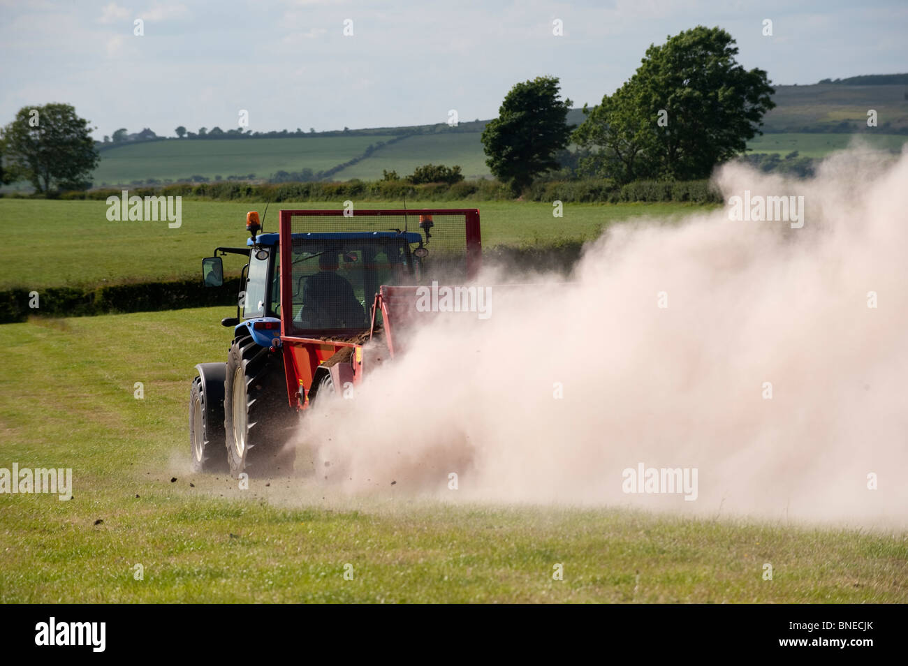 Farmer spreading chicken manure mixed with lime on newly harvested