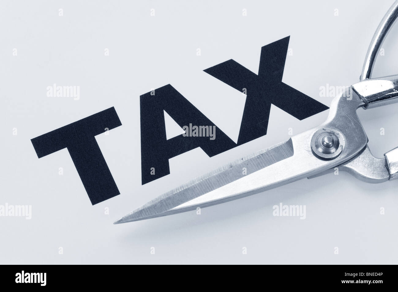 text of tax and scissors, concept of tax cut Stock Photo