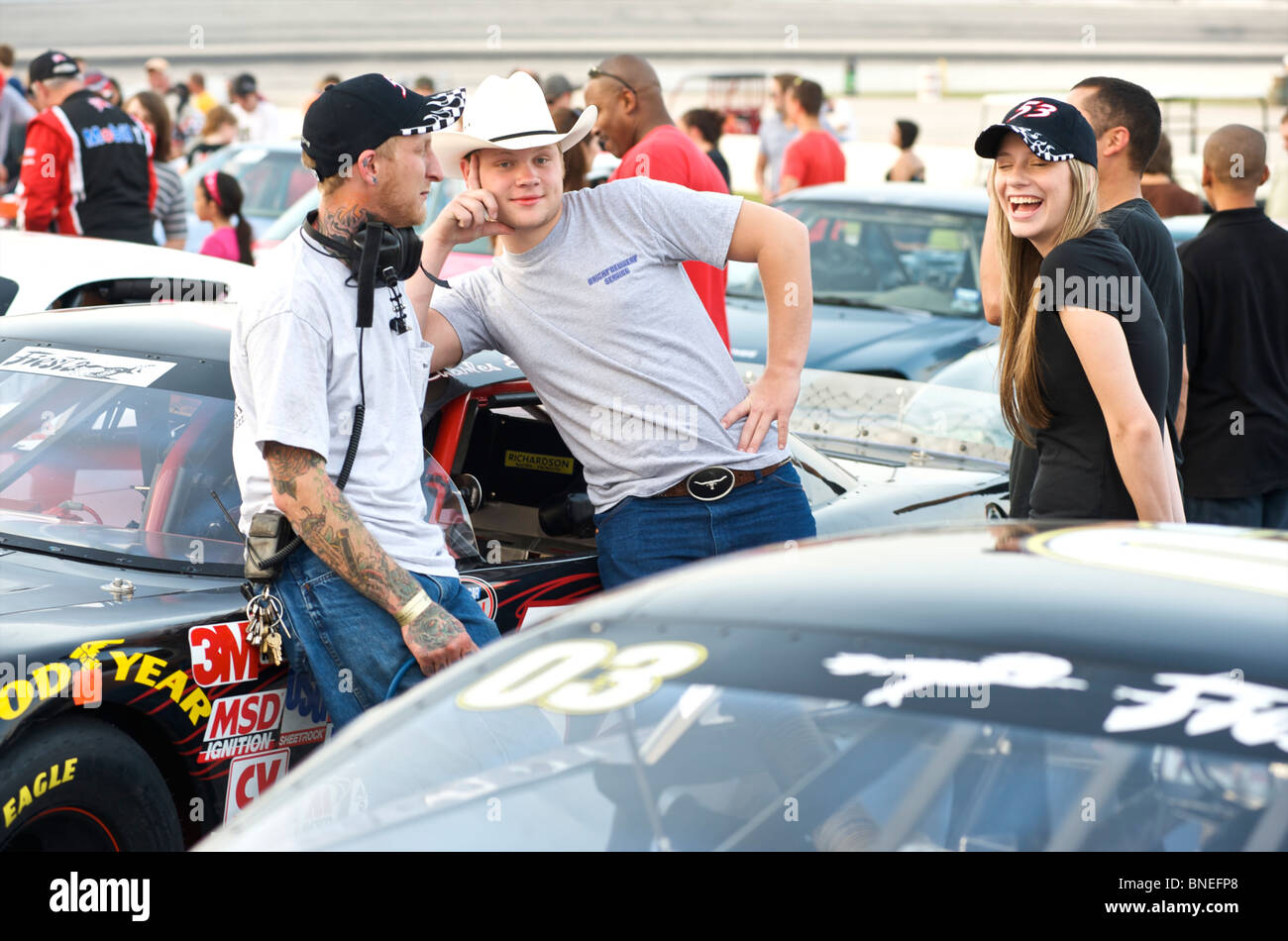 Friends in discussion at Nascar car racing circuit Houston, Texas, USA Stock Photo