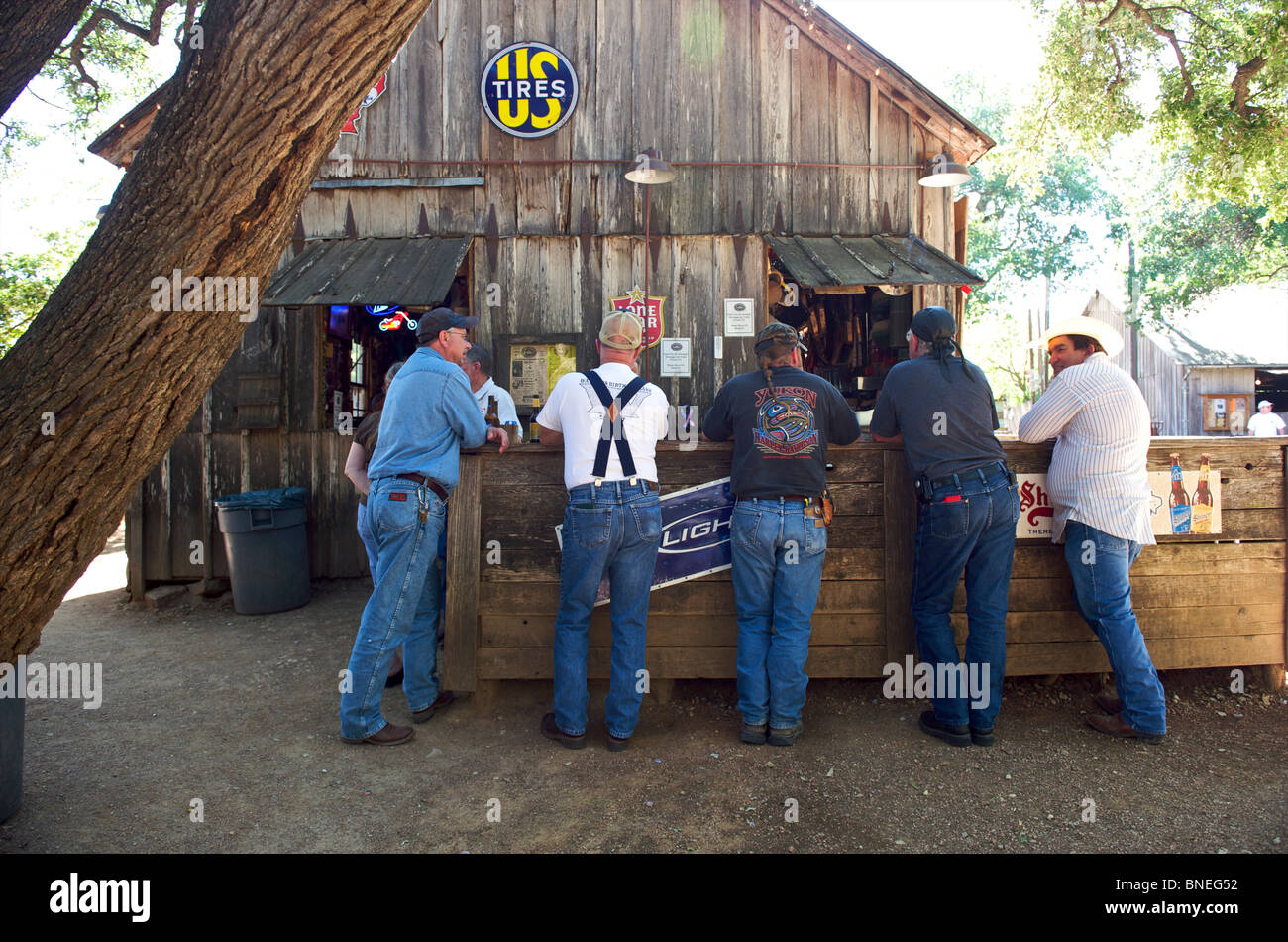 Men standing at outdoor bar in Luckenbach, Taxes, USA Stock Photo