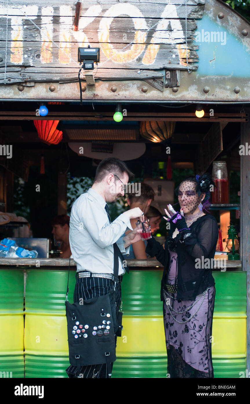 Goth couple enjoying a drink at a bar at the Tollwood Summer festival in Munich, Germany Stock Photo