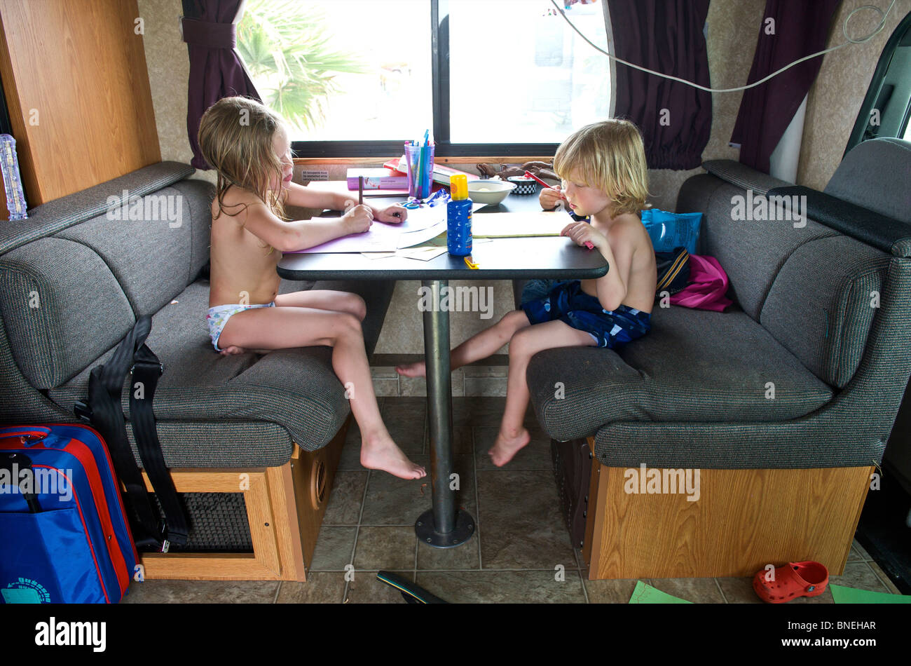 Children making drawings inside a camper campervan RV in Texas, USA Stock Photo