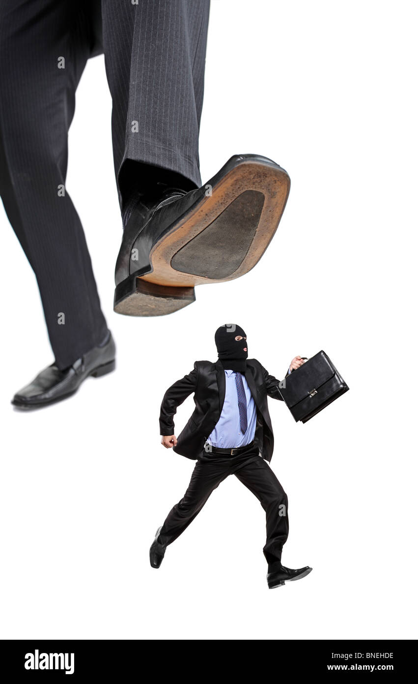 An affraid burglar running away from a big foot Stock Photo