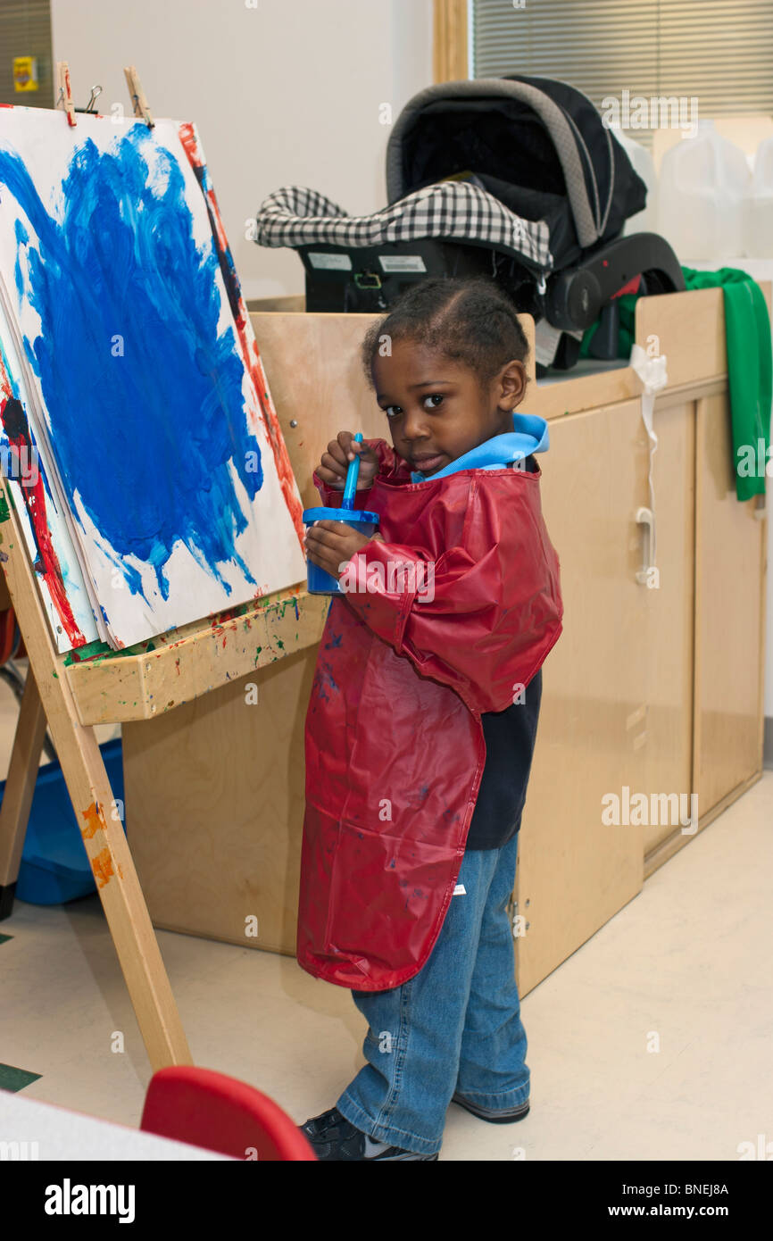 preschool classroom 4 year old African American preschool boy painting