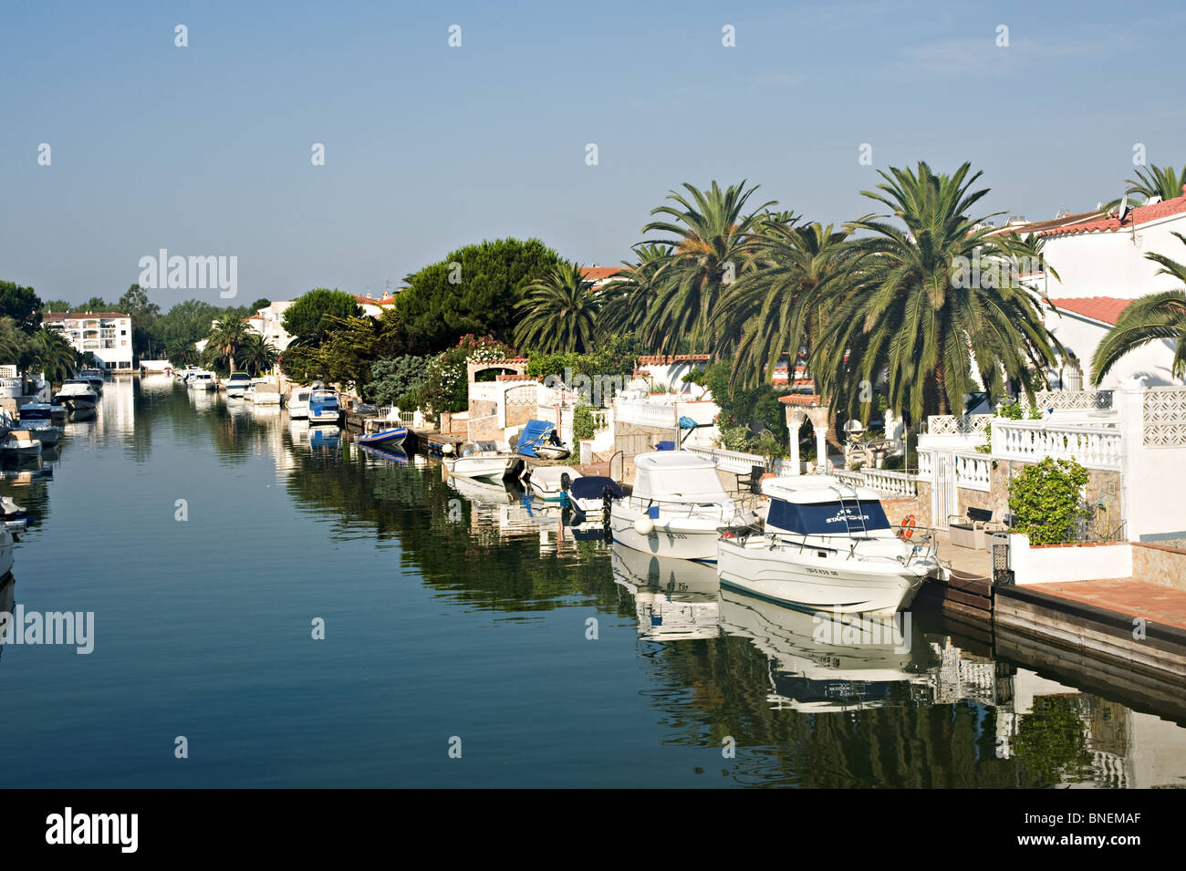 Villas and Luxury Boats Moored in Canal Network at Empuriabrava Costa Brava Catalonia Spain Espana Stock Photo