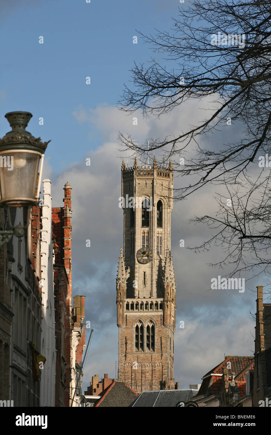 The tower of the Belfort (belfry) taken from the Steenstraat with a stormy winter sky Stock Photo