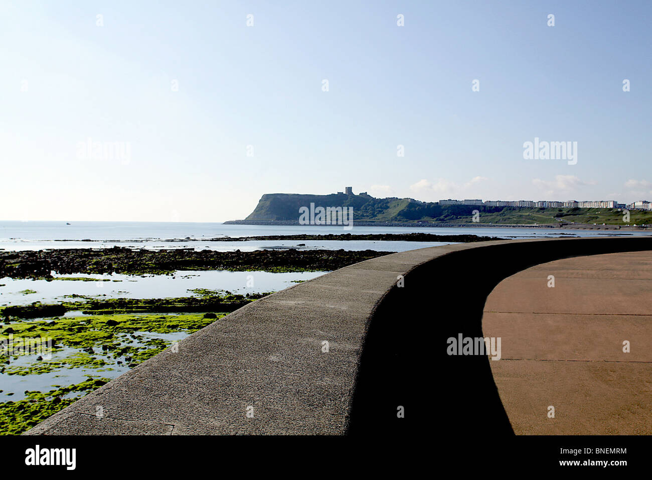 Scarborough Castle viewed across North Bay from pedestrian waterfront sidewalk, North Yorkshire, England. Stock Photo
