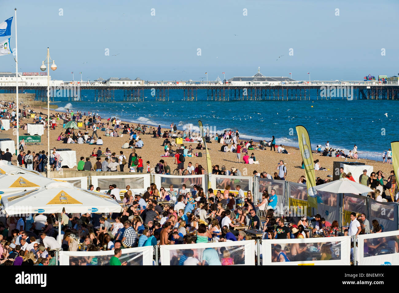Crowded bars and beach on hot summer day, Brighton, East Sussex, United