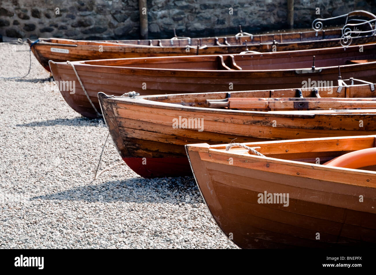 A row of wooden rowing boats for hire on the foreshore at Derwent