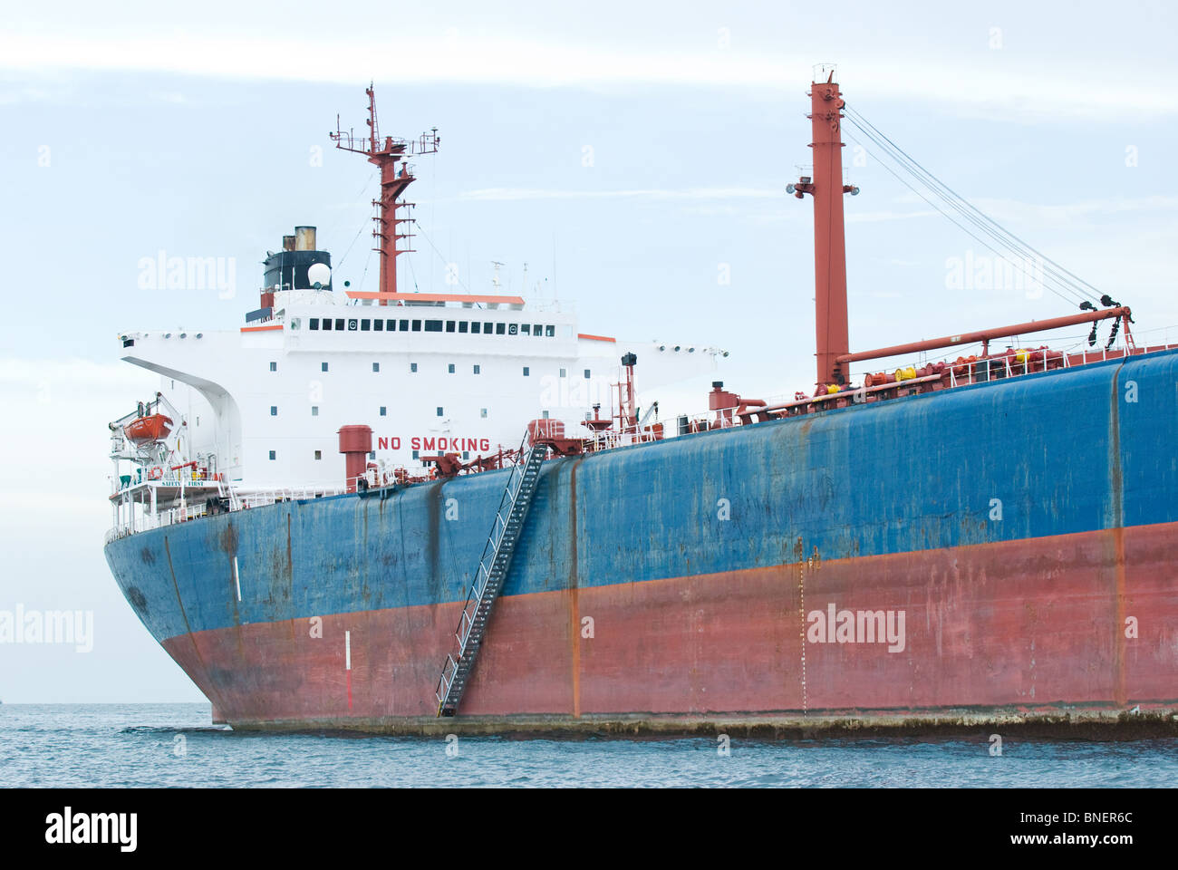 Rusty, old oil tanker moored in calm waters Stock Photo