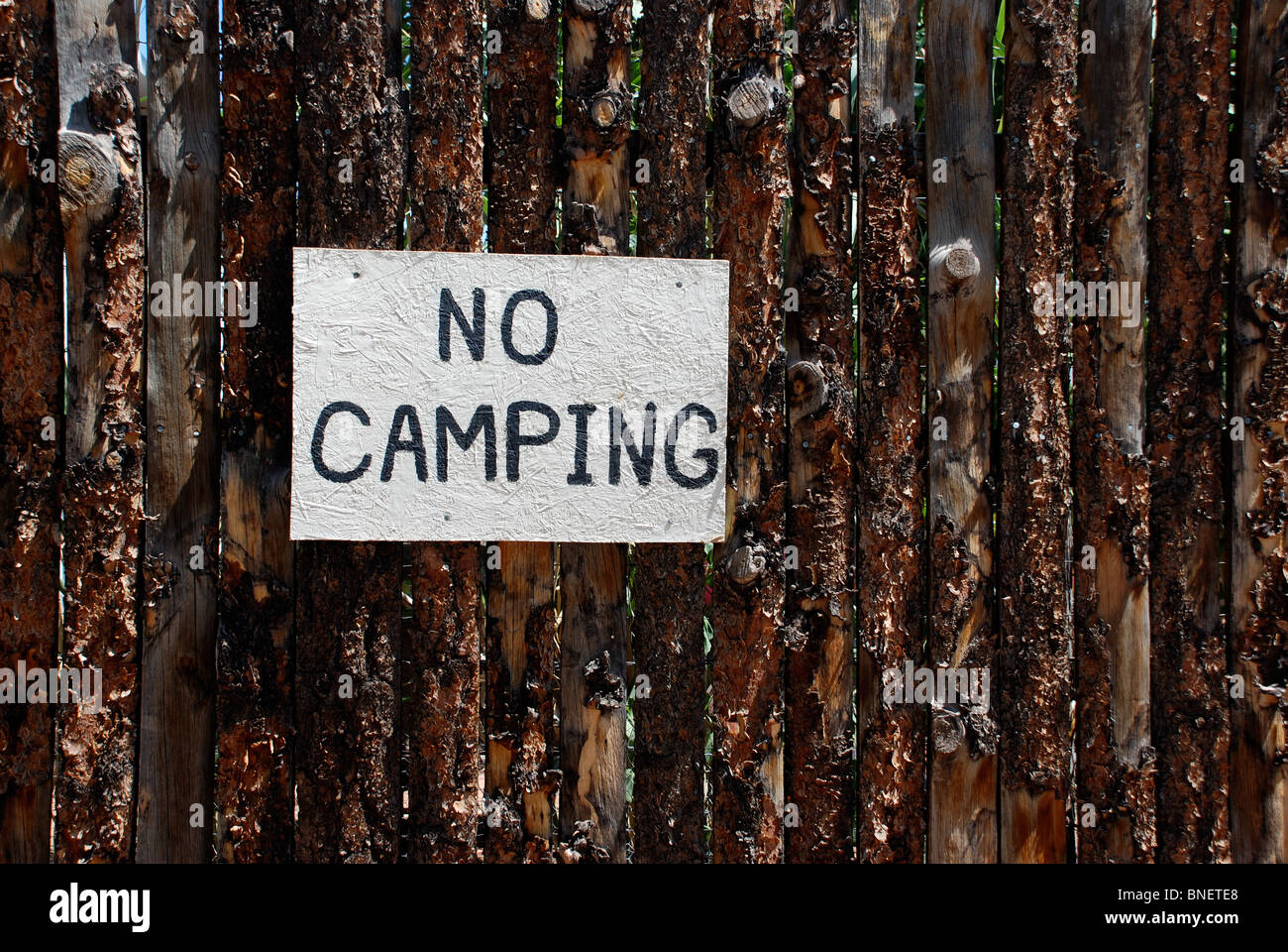 No Camping sign on wooden fence Stock Photo