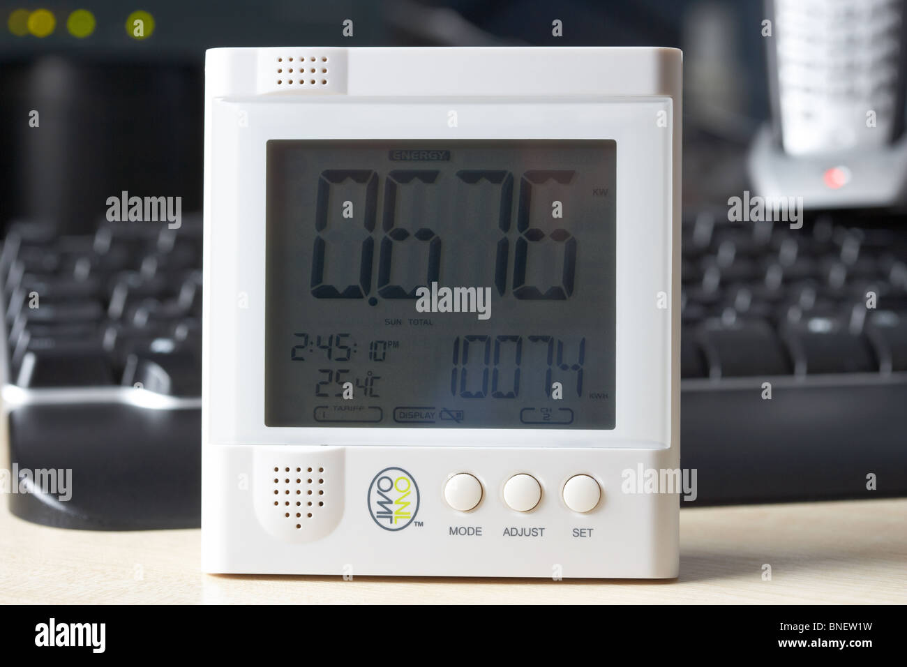 using a wireless electricity monitor to monitor electricity usage in a home office environment in the uk Stock Photo