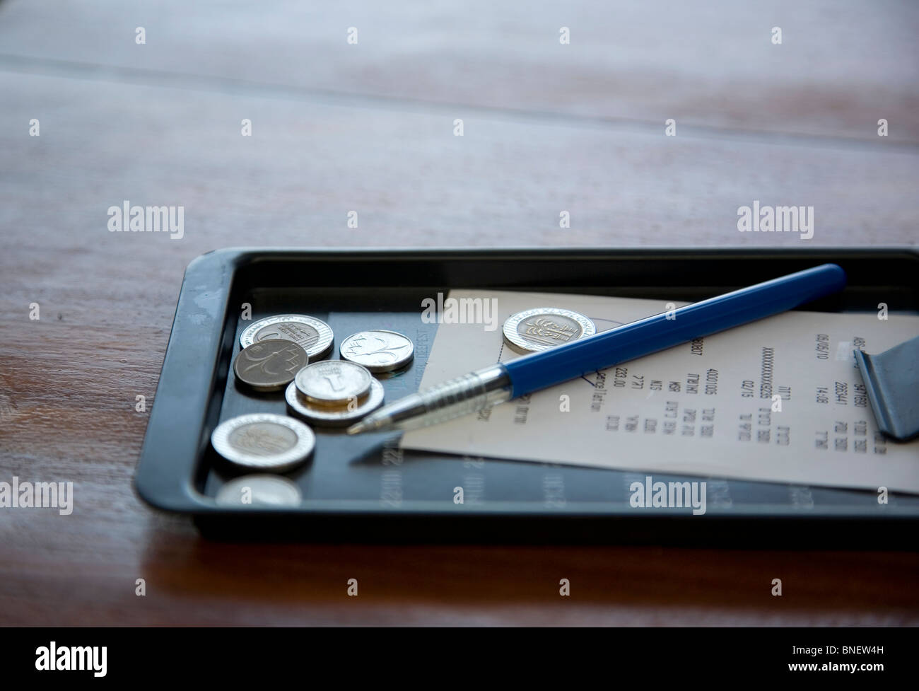 Bill and coins, change in black tray Israel Stock Photo Alamy