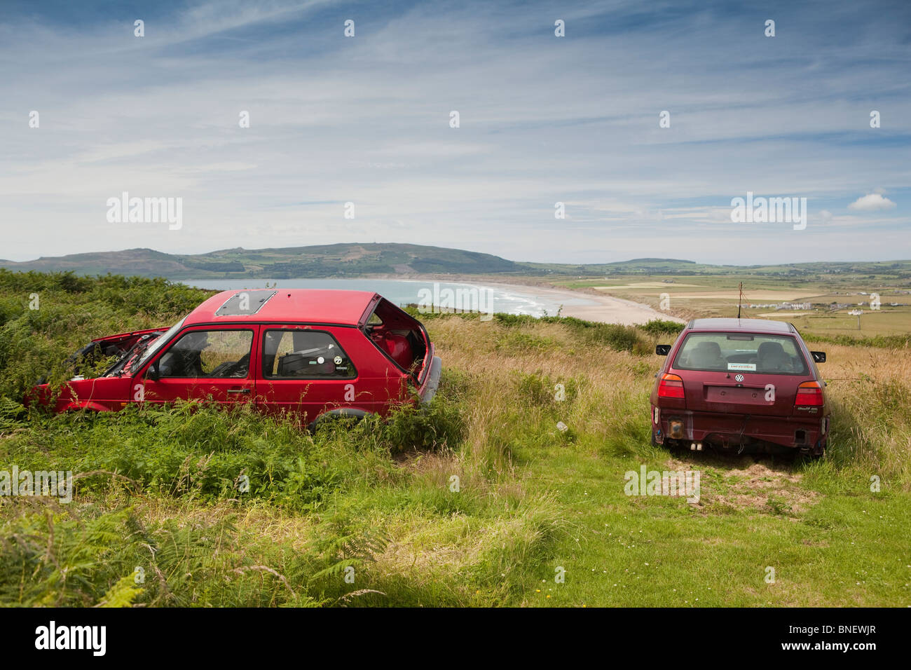 UK, Wales, Gwynedd, Lleyn peninsula, Mynydd Cilan, abandoned car blighting scenic view of Porth Neigwl Stock Photo