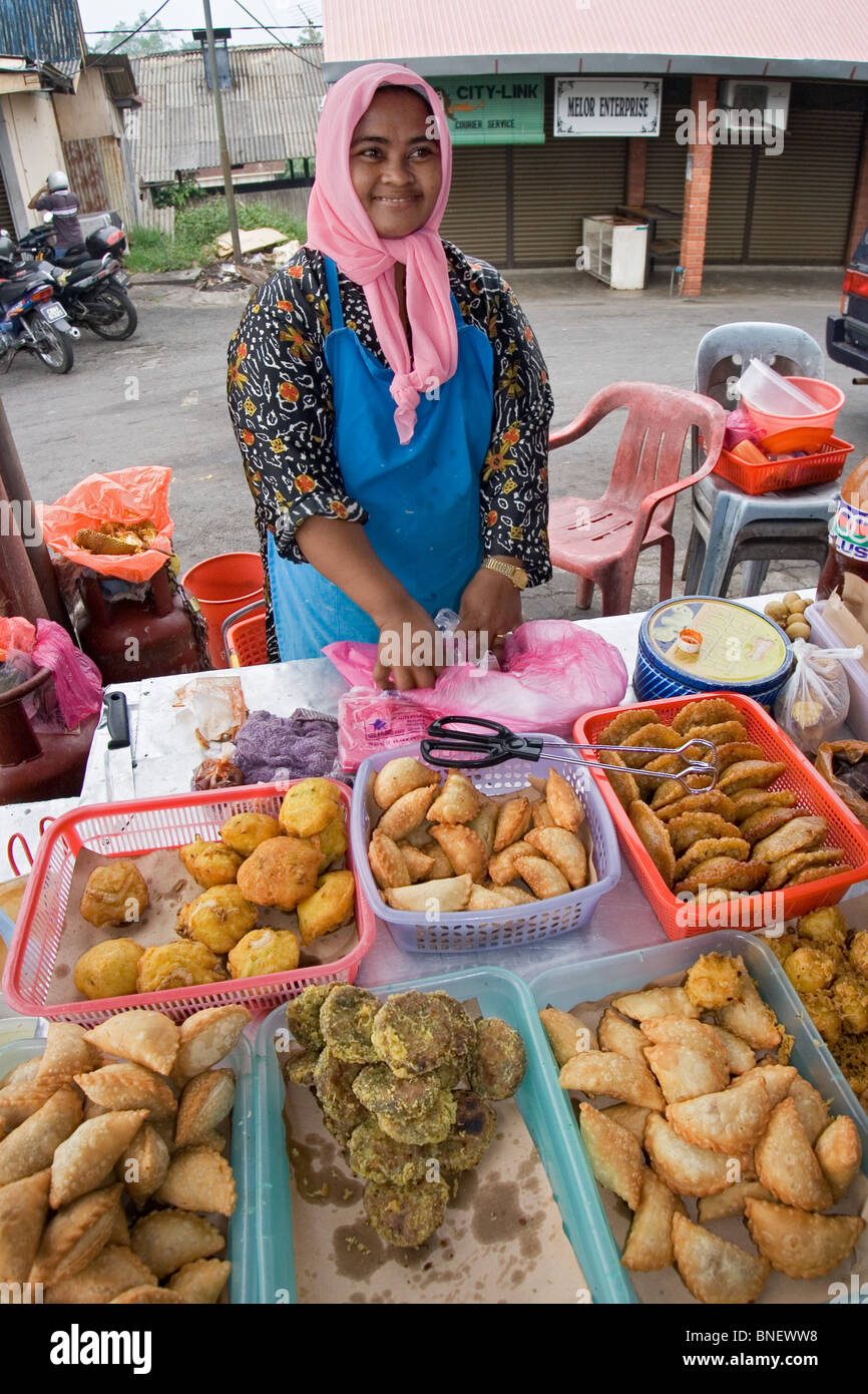 Malaysian woman selling hot food at a market in Malaysia Stock Photo