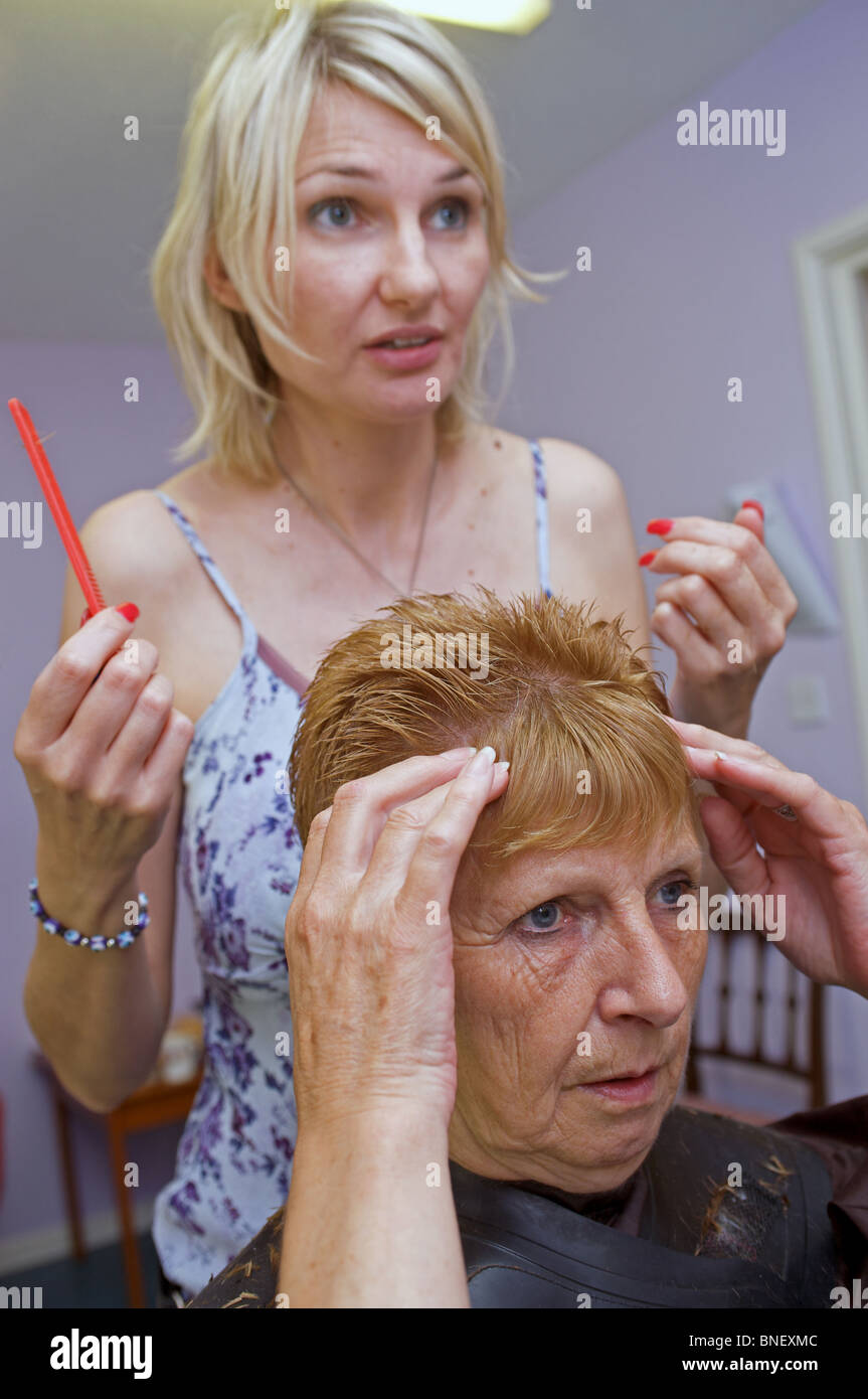 Resident in a care home telling a hairdresser what style she would like Stock Photo Alamy
