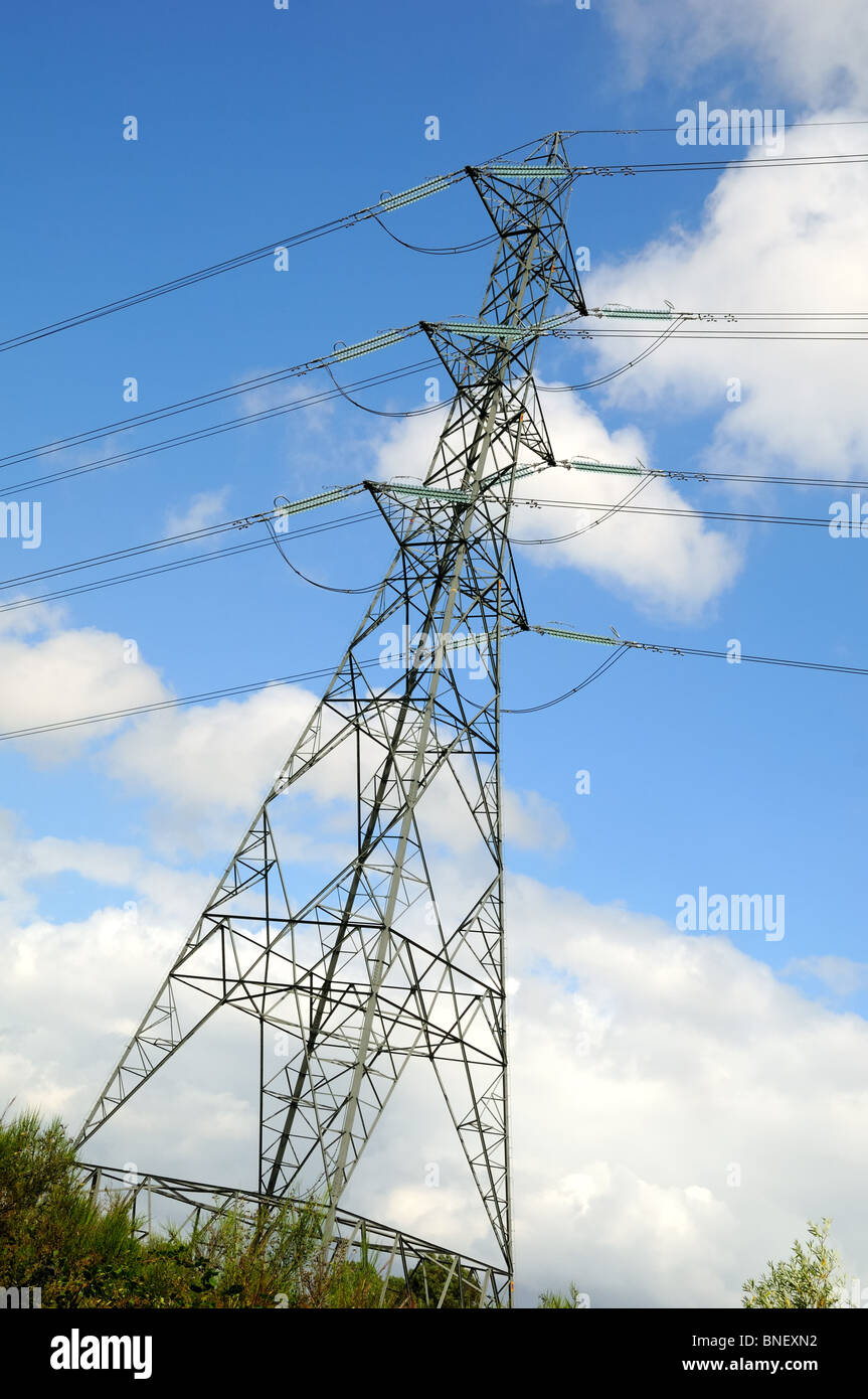Electricity pylon against blue cloudy sky Stock Photo - Alamy