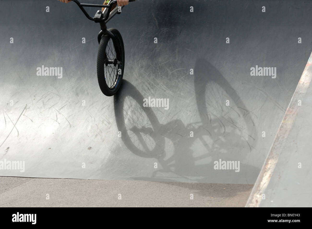 A shadow of a BMX stunt bike on a metal ramp in a skate park Stock ...