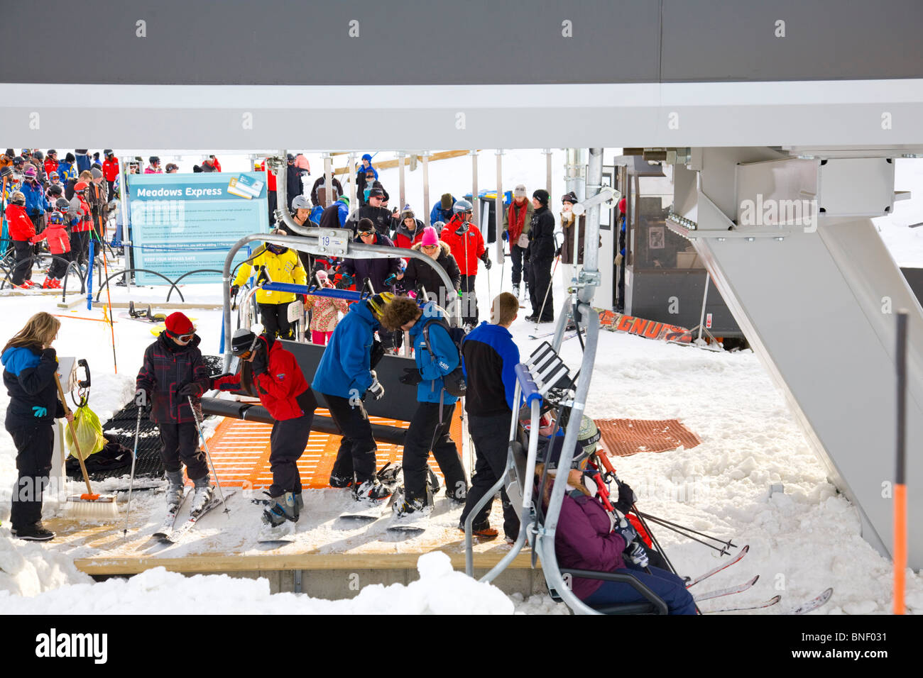 people about to get on a quad chairlift at coronet peak ski resort queenstown Stock Photo