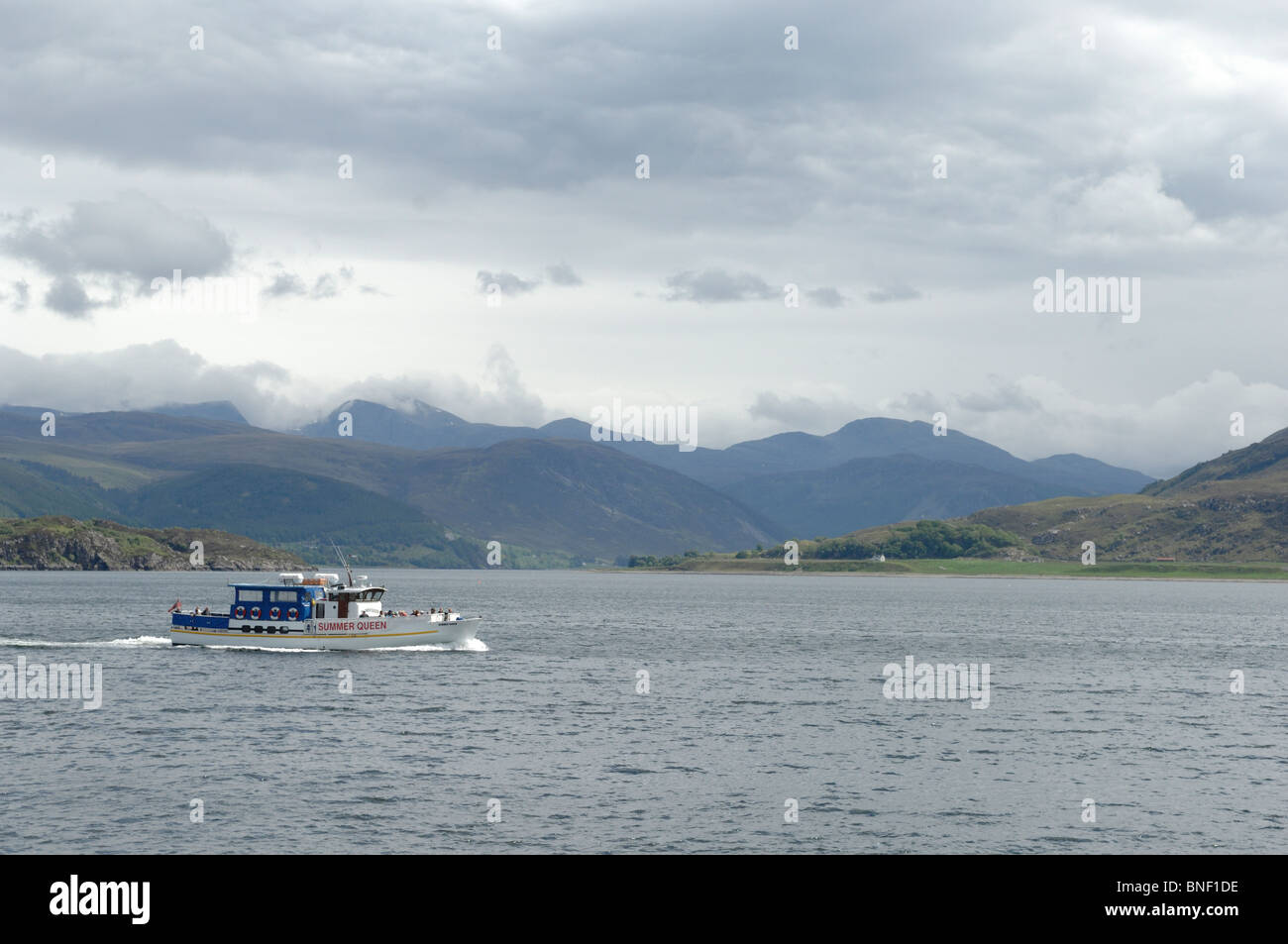 A tourist sightseeing boat on Lock Broom off the coast of Ullapool in Ross and Cromarty Scotland Stock Photo