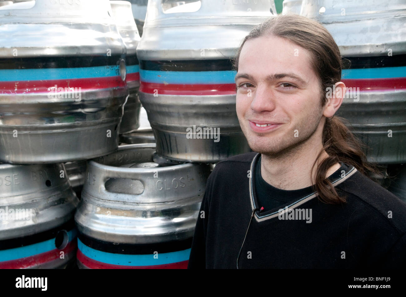 One of the youngest brewers in the country, Joe Thomson, with beer casks outside the Penpont brewery in Cornwall. Stock Photo