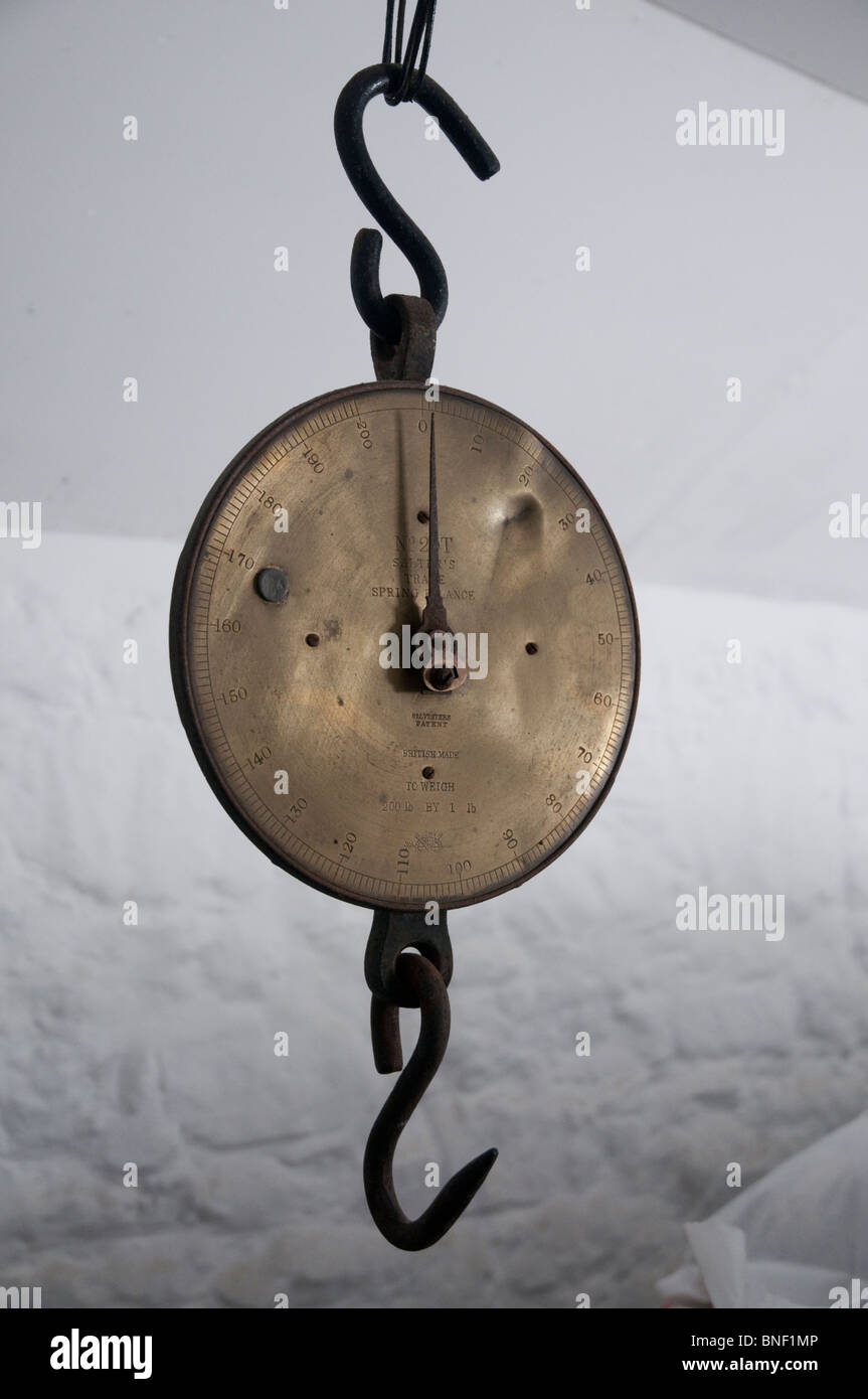 Old fashioned metal scales hanging in a historic brewery in Cornwall Stock Photo