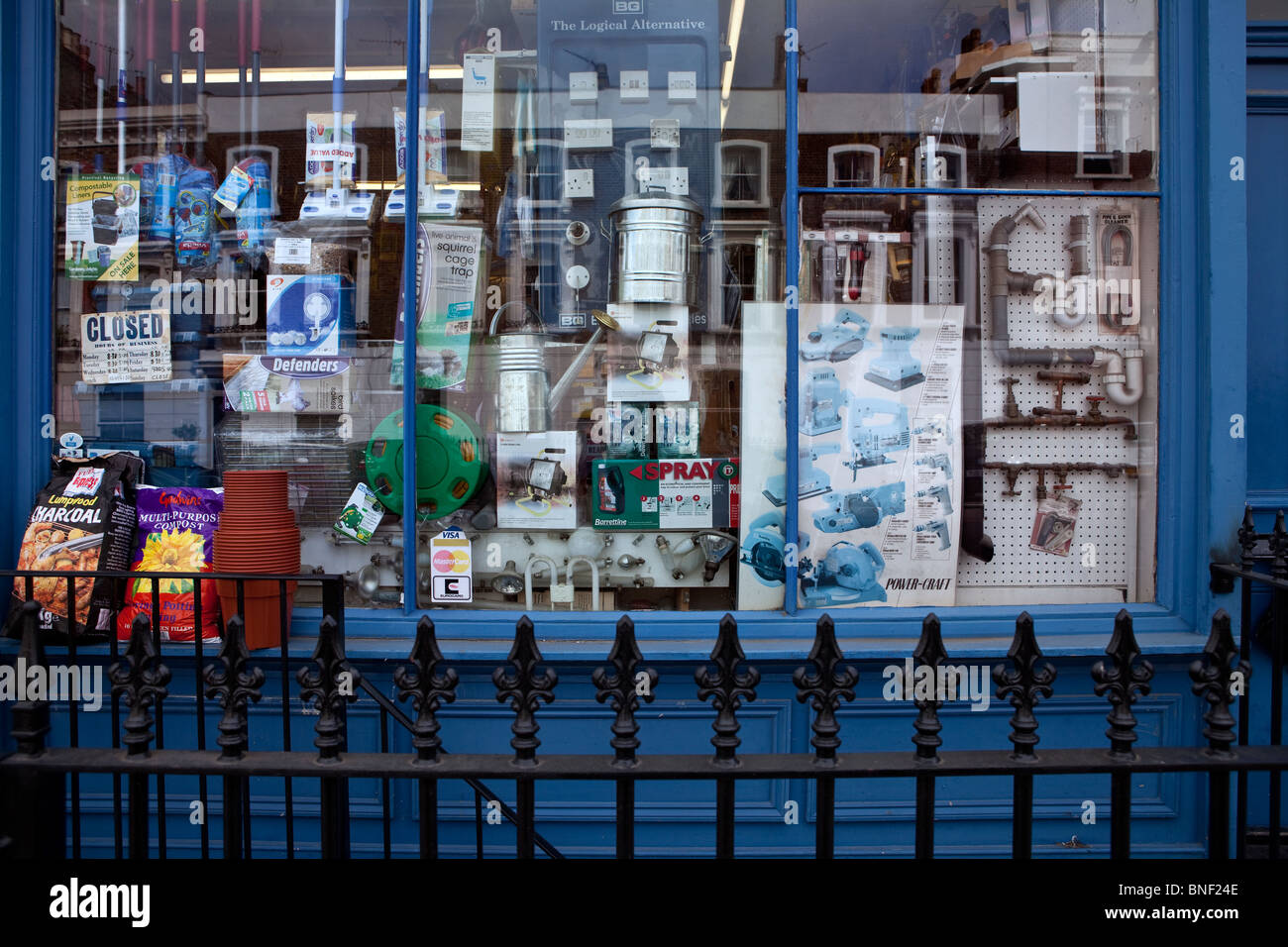 Window of hardware shop behind railings. Stock Photo