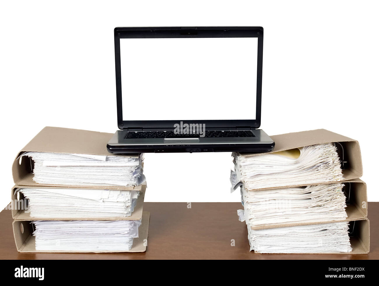 There is laptop near a lot of documents and catalogs Stock Photo