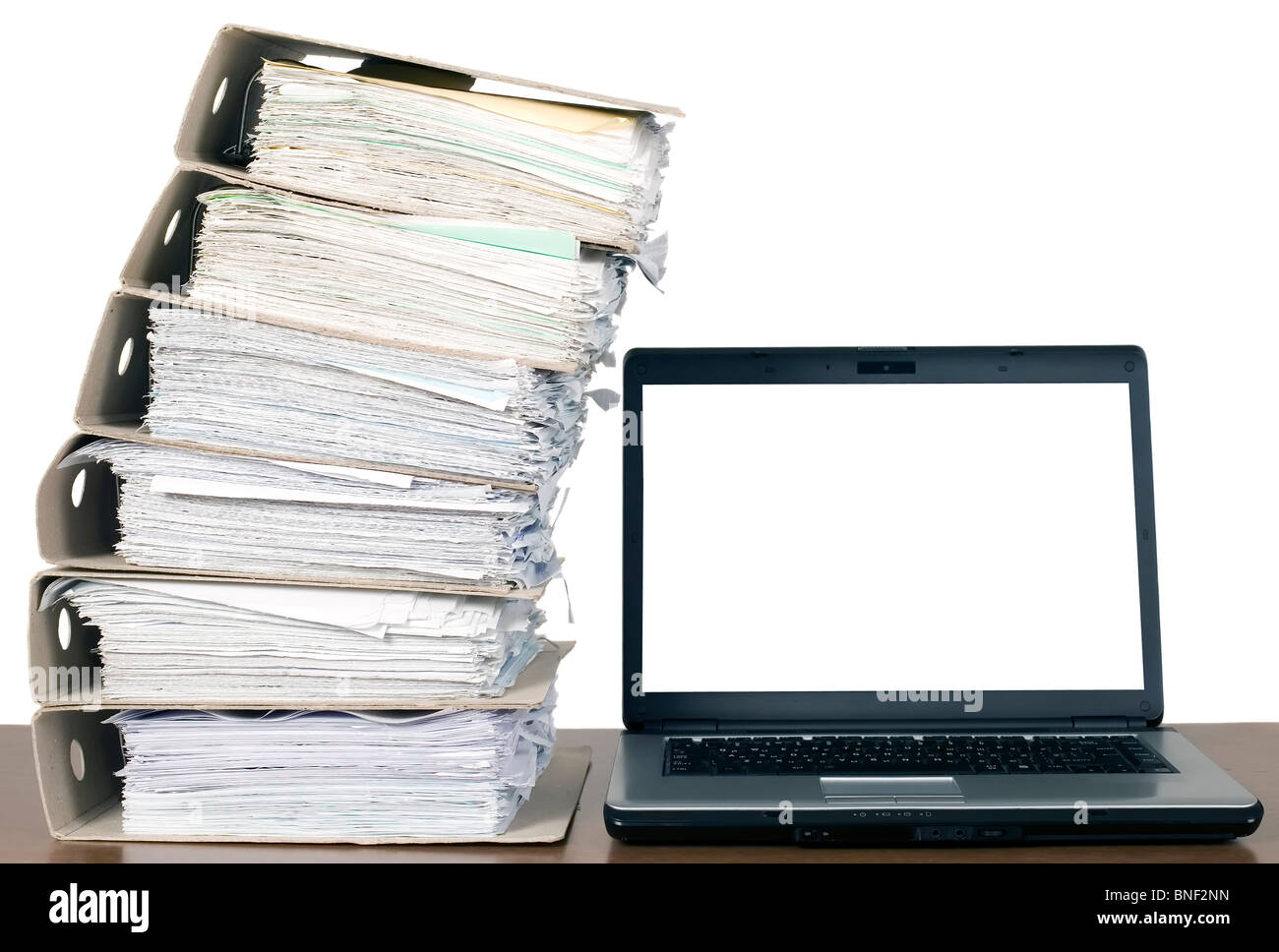 There is laptop near a lot of documents and catalogs Stock Photo