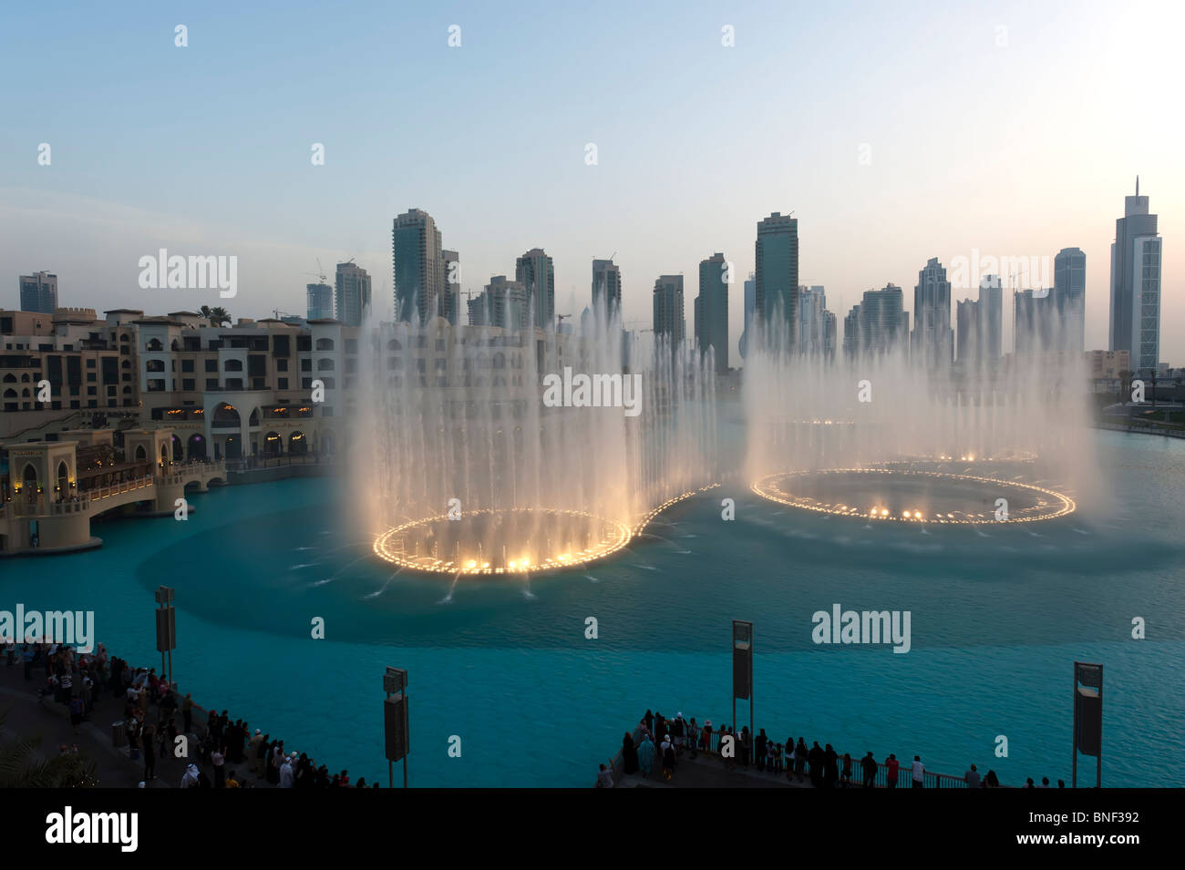 Evening image of the illuminated Dubai Fountains at Downtown Dubai Mall, Dubai, UAE Stock Photo