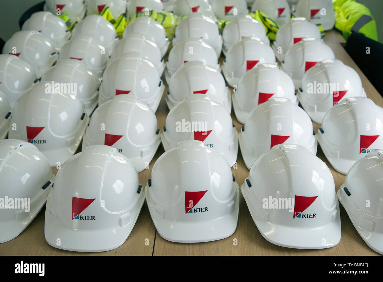 Industrial construction hard hats in rows. Stock Photo