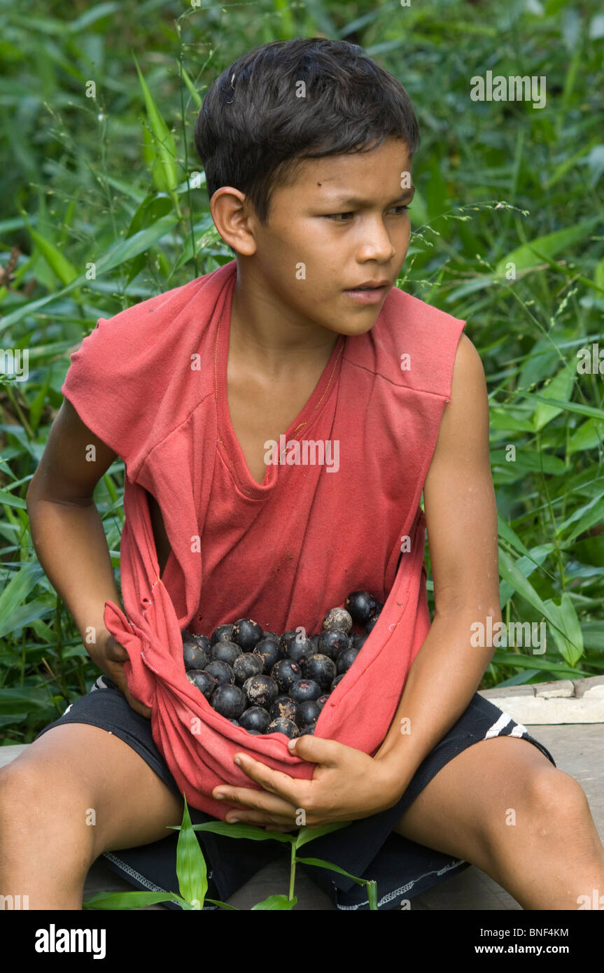 Boy holding Sinamillo fruits, Bretana, Rio Puinahua, Loreto Region, Peru Stock Photo
