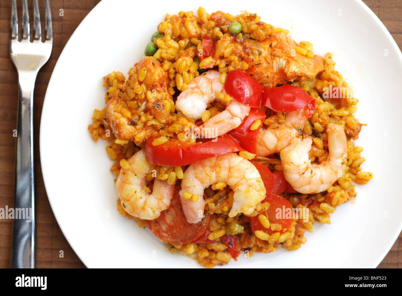 Authentic Homemade Spanish Style Paella Meal With Chorizo Sausage, Red Peppers And King Prawns Cooked In Spices And Rice As A Flat Lay With No People Stock Photo