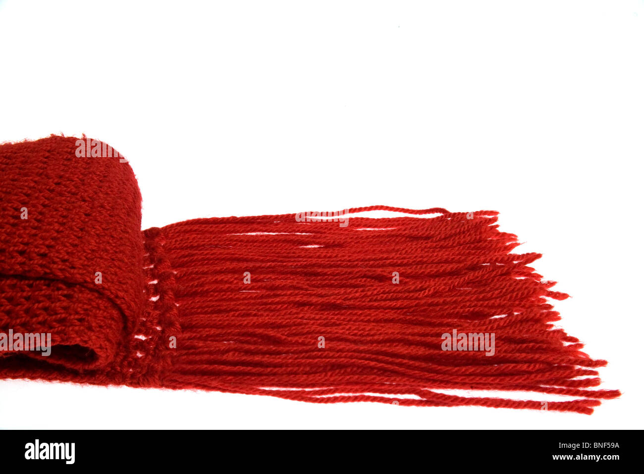 A woolen red scarf with long fringes. Stock Photo