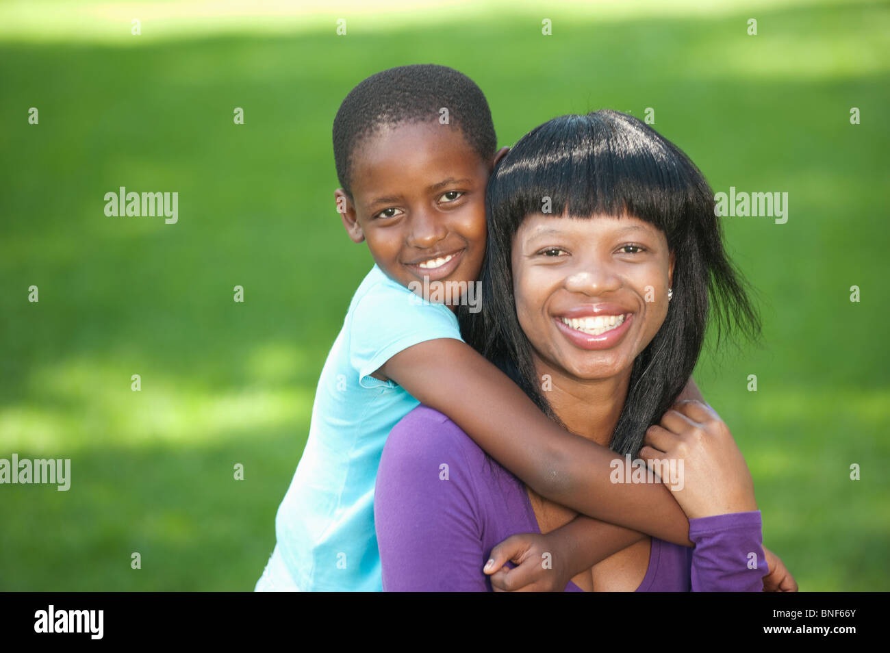 Portrait of girl (8-9) embracing mother, outdoors, Johannesburg, Gauteng Province, South Africa Stock Photo