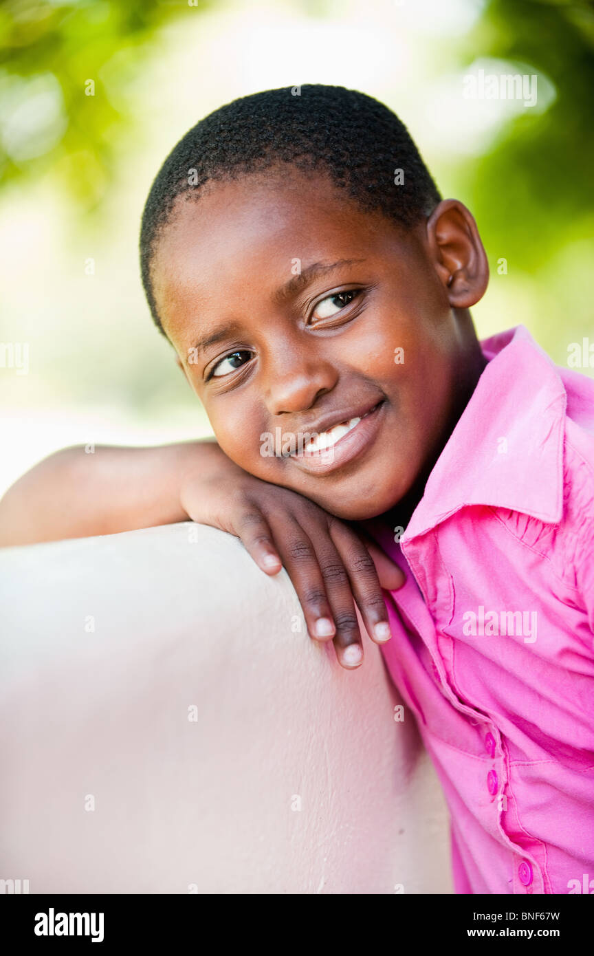 Girl (8-9) leaning outdoors, Johannesburg, Gauteng Province, South Africa Stock Photo