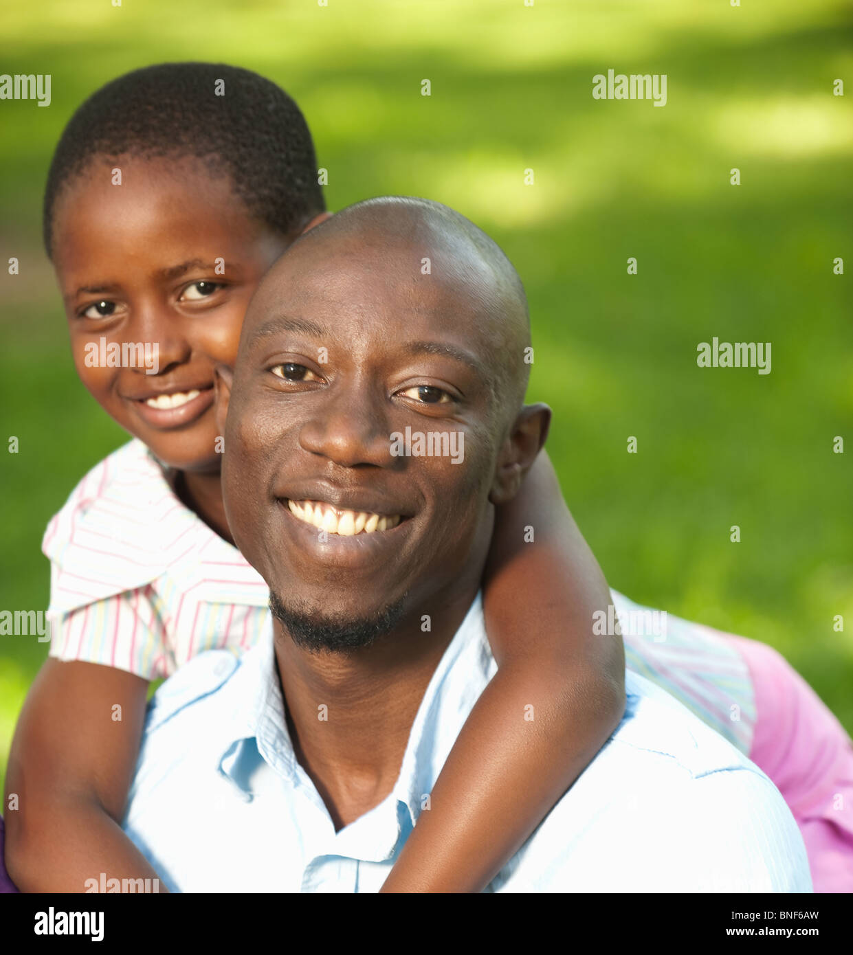 Portrait of girl (8-9) embracing father, outdoors, Johannesburg, Gauteng Province, South Africa Stock Photo