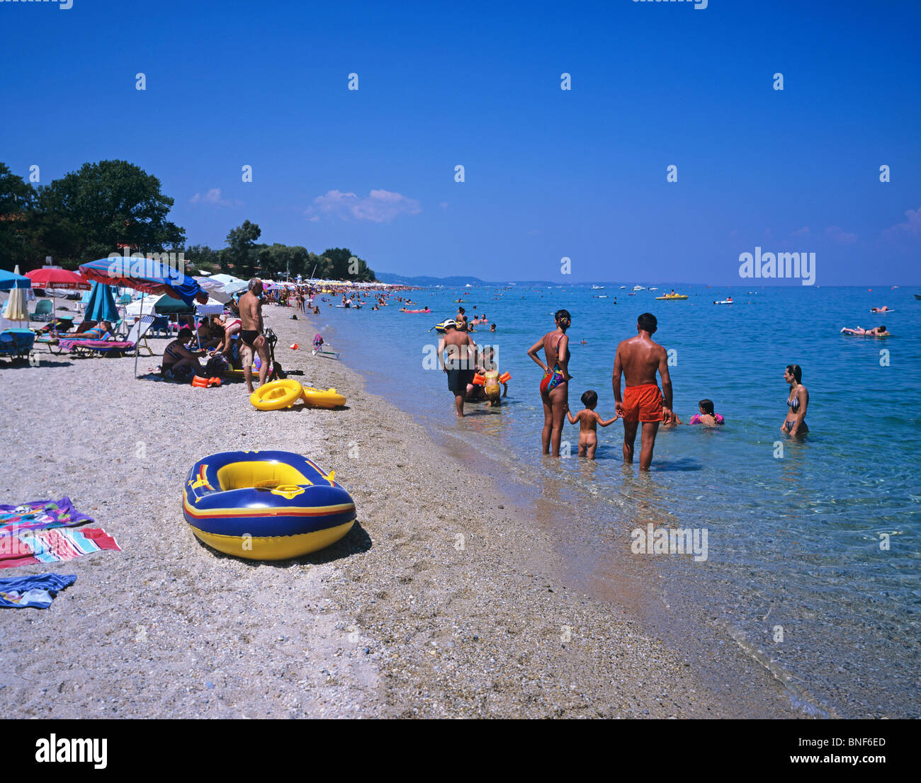 Beach scene at the popular resort of Chaniotis on the east coast of the Kassandra Peninsula Stock Photo